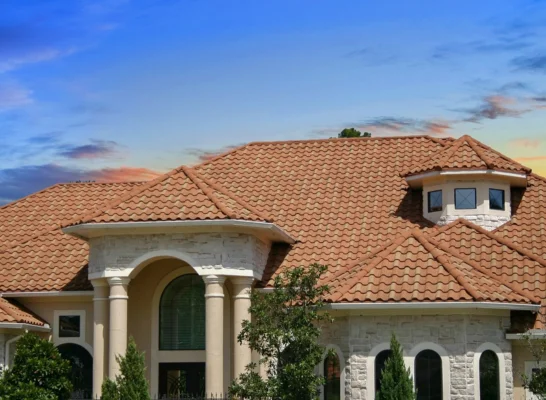 charming home with a vibrant red roof, showcasing quality roofing tiles from a reputable manufacturer