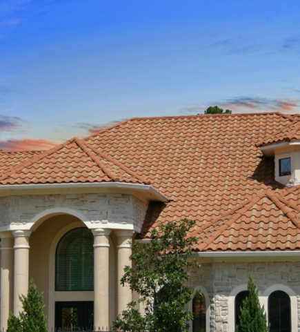 An appealing villa house with stunning red roofing tiles, set against an amazing backdrop.